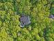 Aerial view of a home with a pool surrounded by lush green trees at 1255 Cold Harbor Dr, Roswell, GA 30075