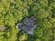 Aerial view of a home with pool, surrounded by lush green trees at 1255 Cold Harbor Dr, Roswell, GA 30075