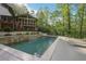 Stunning backyard featuring a pool with a waterfall, lush landscaping, and outdoor living space at 1255 Cold Harbor Dr, Roswell, GA 30075