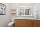 Modern bathroom featuring a bright LED mirror over a granite countertop and wood accents at 1255 Cold Harbor Dr, Roswell, GA 30075