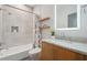 Clean bathroom with tub shower combo, wood shelving, and a modern vanity offering a functional and stylish space at 1255 Cold Harbor Dr, Roswell, GA 30075