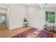 Bright bedroom featuring wood floors, large windows, and a colorful area rug at 1255 Cold Harbor Dr, Roswell, GA 30075