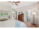 Bright bedroom with a ceiling fan, hardwood floors, and a closet with mirrored sliding doors at 1255 Cold Harbor Dr, Roswell, GA 30075