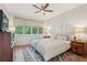 Cozy bedroom with natural light, ceiling fan, and stylish area rug at 1255 Cold Harbor Dr, Roswell, GA 30075