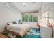 Bright bedroom featuring a queen-sized bed, desk area, and large windows offering natural light and outdoor views at 1255 Cold Harbor Dr, Roswell, GA 30075