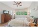 Comfortable bedroom featuring a ceiling fan, bright windows, and neutral decor at 1255 Cold Harbor Dr, Roswell, GA 30075