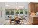 Bright breakfast nook with wooded views and an adjacent modern kitchen design at 1255 Cold Harbor Dr, Roswell, GA 30075