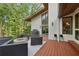 Inviting deck with a fire pit, grill, and stylish seating for outdoor relaxation and entertaining at 1255 Cold Harbor Dr, Roswell, GA 30075