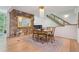 Open dining area features a stone accent wall, wooden floors, and modern lighting fixture at 1255 Cold Harbor Dr, Roswell, GA 30075