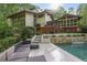 Beautiful home exterior with a pool, tiered landscaping, and spacious outdoor living areas at 1255 Cold Harbor Dr, Roswell, GA 30075