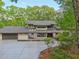 Modern two-story home with expansive driveway surrounded by mature trees at 1255 Cold Harbor Dr, Roswell, GA 30075