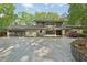 Contemporary home featuring a large driveway, modern architecture, and beautifully maintained landscaping at 1255 Cold Harbor Dr, Roswell, GA 30075