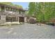 Elegant home with a unique architectural design, stone accents, and a patterned concrete driveway at 1255 Cold Harbor Dr, Roswell, GA 30075
