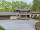 Stunning home with modern design, large windows, and spacious driveway surrounded by lush greenery at 1255 Cold Harbor Dr, Roswell, GA 30075