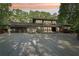 Stunning modern home featuring large windows, a spacious driveway, and lush landscaping for a luxurious feel at 1255 Cold Harbor Dr, Roswell, GA 30075