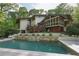 Lush backyard view of a house featuring a pool with fountain, manicured garden, and ample patio space at 1255 Cold Harbor Dr, Roswell, GA 30075