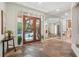 Welcoming foyer featuring a unique wooden door, stone flooring, and plenty of natural light at 1255 Cold Harbor Dr, Roswell, GA 30075
