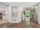 Inviting foyer features stone floors, modern art niche, and access to the kitchen and staircase at 1255 Cold Harbor Dr, Roswell, GA 30075