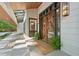 Striking front entrance showcasing a custom wooden door, modern lighting, and decorative stone landscaping at 1255 Cold Harbor Dr, Roswell, GA 30075