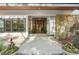 Inviting entrance with a custom wooden door, stone accents, and neatly arranged landscaping at 1255 Cold Harbor Dr, Roswell, GA 30075