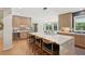 Open kitchen layout with eat-in island and view into the dining room with outdoor views at 1255 Cold Harbor Dr, Roswell, GA 30075
