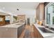 Bright kitchen with central island and stainless steel sink under a large window at 1255 Cold Harbor Dr, Roswell, GA 30075