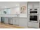 Basement kitchenette with gray cabinets, marble backsplash, and stainless-steel appliances at 1255 Cold Harbor Dr, Roswell, GA 30075