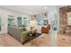 Inviting living room with built-in shelving, stone accent wall, and hardwood floors at 1255 Cold Harbor Dr, Roswell, GA 30075