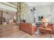Open-concept living room featuring a stone fireplace, wood floors and stairs to a second floor at 1255 Cold Harbor Dr, Roswell, GA 30075