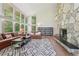 Bright living room boasts hardwood floors, a stone fireplace, and scenic views at 1255 Cold Harbor Dr, Roswell, GA 30075
