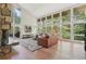 Spacious living room features large windows, stone fireplace, and comfortable seating at 1255 Cold Harbor Dr, Roswell, GA 30075