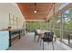 Enclosed patio with lights, tables, chairs, and a view of surrounding trees at 1255 Cold Harbor Dr, Roswell, GA 30075