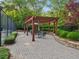 Relax in this lovely outdoor patio with pergola and stone garden; a perfect spot for relaxation and entertaining at 1255 Cold Harbor Dr, Roswell, GA 30075