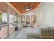 Enclosed patio with lights, ceiling fan, full-length windows, couches and side tables at 1255 Cold Harbor Dr, Roswell, GA 30075