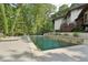 Private pool area with a waterfall feature, surrounded by greenery and patio space for relaxing at 1255 Cold Harbor Dr, Roswell, GA 30075