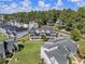 Exterior aerial of modern townhomes in a lakeside community with manicured lawns at 14020 Tributary Ln, Villa Rica, GA 30180