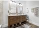 Modern bathroom with a double sink vanity, stylish mirrors and luxury vinyl plank flooring at 14020 Tributary Ln, Villa Rica, GA 30180