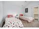 Bright bedroom features two twin beds, neutral walls, and sliding door access to an outdoor balcony at 14020 Tributary Ln, Villa Rica, GA 30180