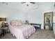 Comfortable bedroom with a vaulted ceiling, featuring neutral decor, ceiling fan, and access to a covered patio at 14020 Tributary Ln, Villa Rica, GA 30180