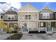 Daytime view of a charming townhome with double balconies and a welcoming front porch, perfect for enjoying outdoor living at 14020 Tributary Ln, Villa Rica, GA 30180