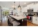 Modern kitchen with granite countertops, stainless steel appliances, and a convenient island with bar seating at 14020 Tributary Ln, Villa Rica, GA 30180