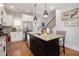 Bright kitchen showcasing the island with granite countertops, modern lighting and stainless appliances at 14020 Tributary Ln, Villa Rica, GA 30180