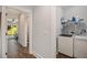 Functional laundry room with modern appliances and convenient shelving for storage at 14020 Tributary Ln, Villa Rica, GA 30180