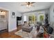 Bright living room featuring hardwood floors, a comfortable sofa, and access to a private balcony at 14020 Tributary Ln, Villa Rica, GA 30180