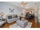 Open-concept living room with hardwood floors, comfortable seating, and ample natural light at 14020 Tributary Ln, Villa Rica, GA 30180
