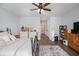 Large bedroom featuring neutral decor, a ceiling fan, and an exterior door leading to the outside at 14020 Tributary Ln, Villa Rica, GA 30180
