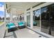 Relaxing covered patio featuring comfortable seating and sliding glass doors with a scenic lake view at 14020 Tributary Ln, Villa Rica, GA 30180