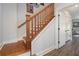 Elegant staircase with wooden handrail and white risers, providing a classic and stylish transition between floors at 14020 Tributary Ln, Villa Rica, GA 30180