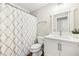 Bathroom featuring white cabinets, shower with patterned curtain, and stylish decor at 1429 Ferocity Ridge Nw Way # 12, Kennesaw, GA 30152