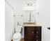 Cozy bathroom featuring a dark cabinet, granite countertops, and a stylish vanity mirror at 1429 Ferocity Ridge Nw Way # 12, Kennesaw, GA 30152